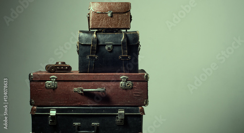 Background stack of old shabby suitcases and camera