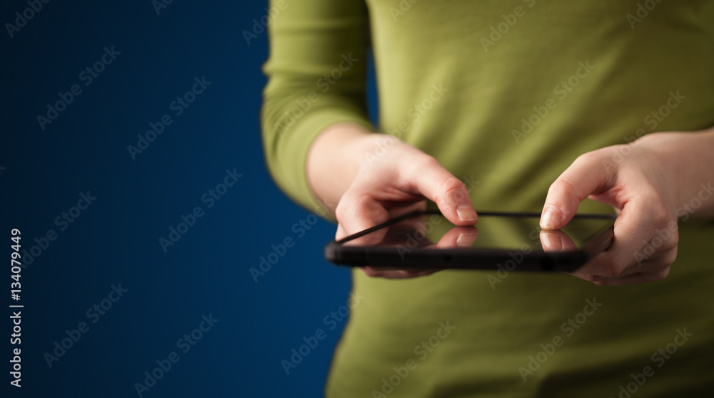 Fototapeta premium Close up of hand holding digital touchpad tablet device