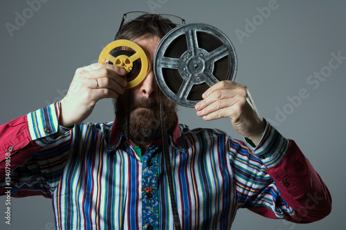 Bearded man with two 16mm film reel