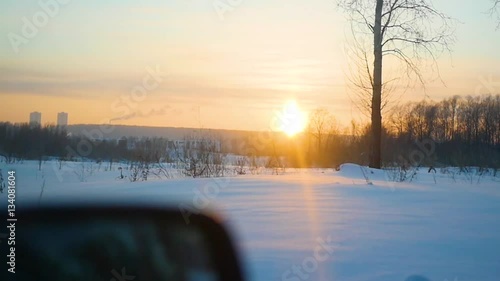 The car rides on winter road at sunset. Point of view
