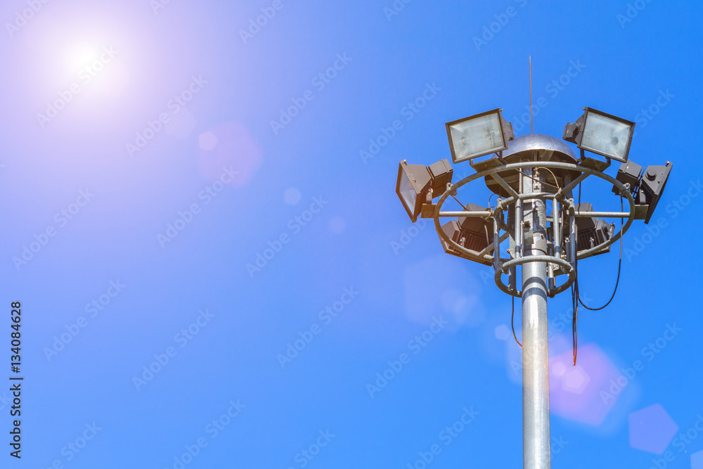Large tall high outdoor stadium halogen spotlight with lamp light turned off and sky clouds. Large tall high outdoor stadium halogen spotlight with lamp light turned off and sky clouds.