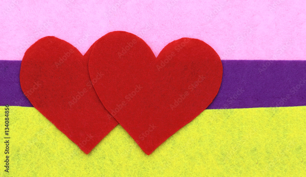 Close up of paper heart shapes on yellow, purple and pink backgr Close up of paper heart shapes on yellow, purple and pink backgr