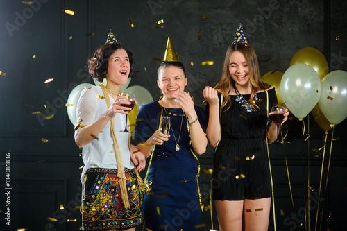 Three young women celebrate something.