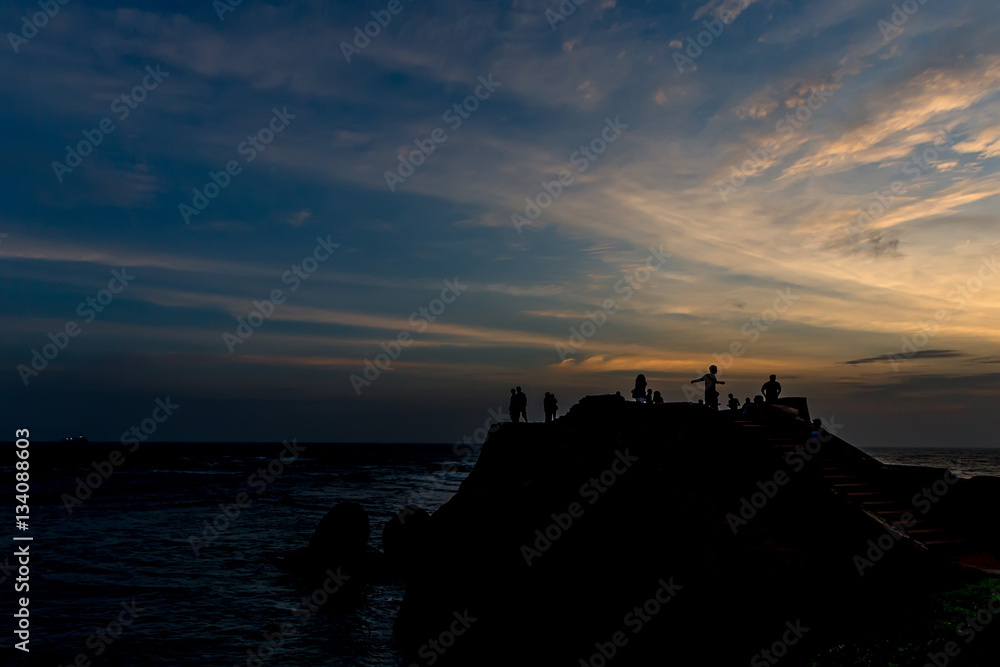Travelers meet night with romantic ocean view