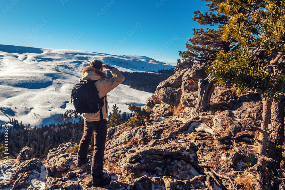 Hiker standing on edge of rock