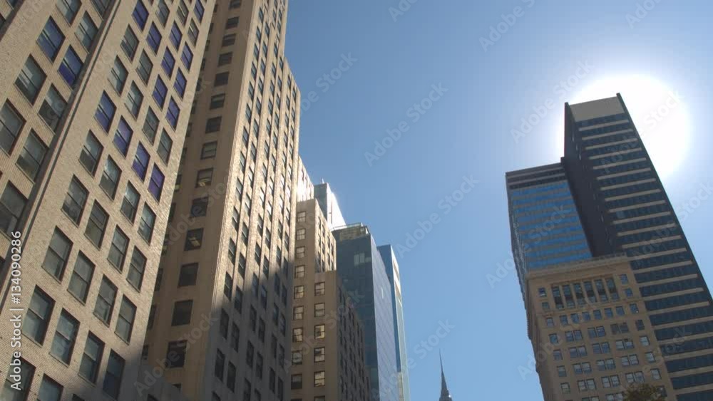 CLOSE UP: Summer sun reflecting in windows of tall modern glassy office building CLOSE UP: Summer sun reflecting in windows of tall modern glassy office building