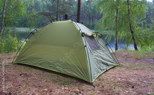 green tents are in the forest