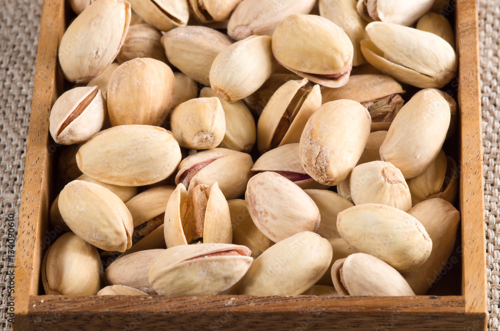 View close-up on pistachios in a wooden box