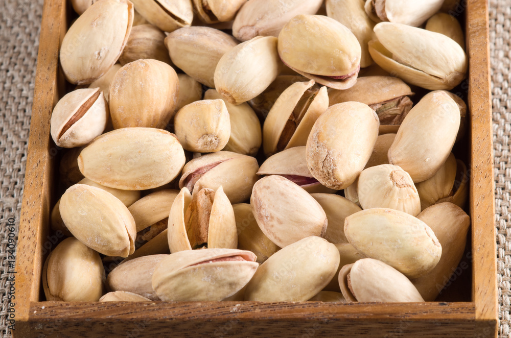 View close-up on pistachios in a wooden box View close-up on pistachios in a wooden box