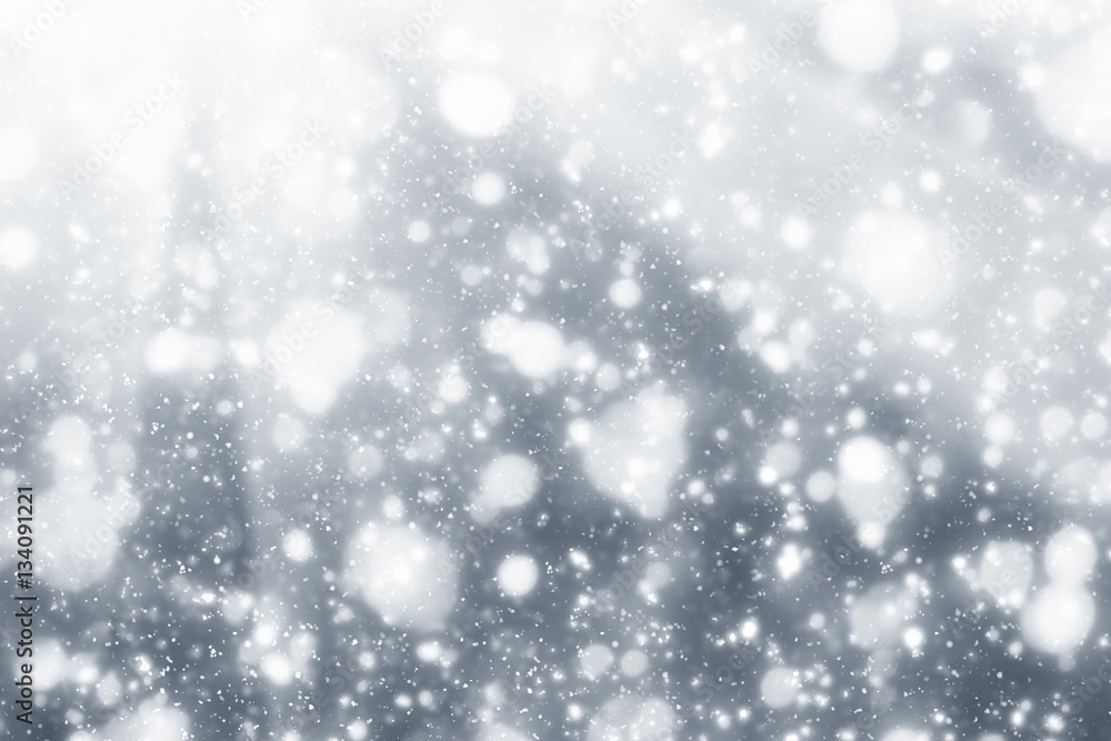 Snowflakes particles and white  bokeh or glitter lights on silver background. Christmas abstract template