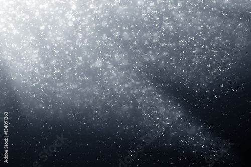 Snowflakes particles and bokeh or glitter lights on silver background. Abstract template