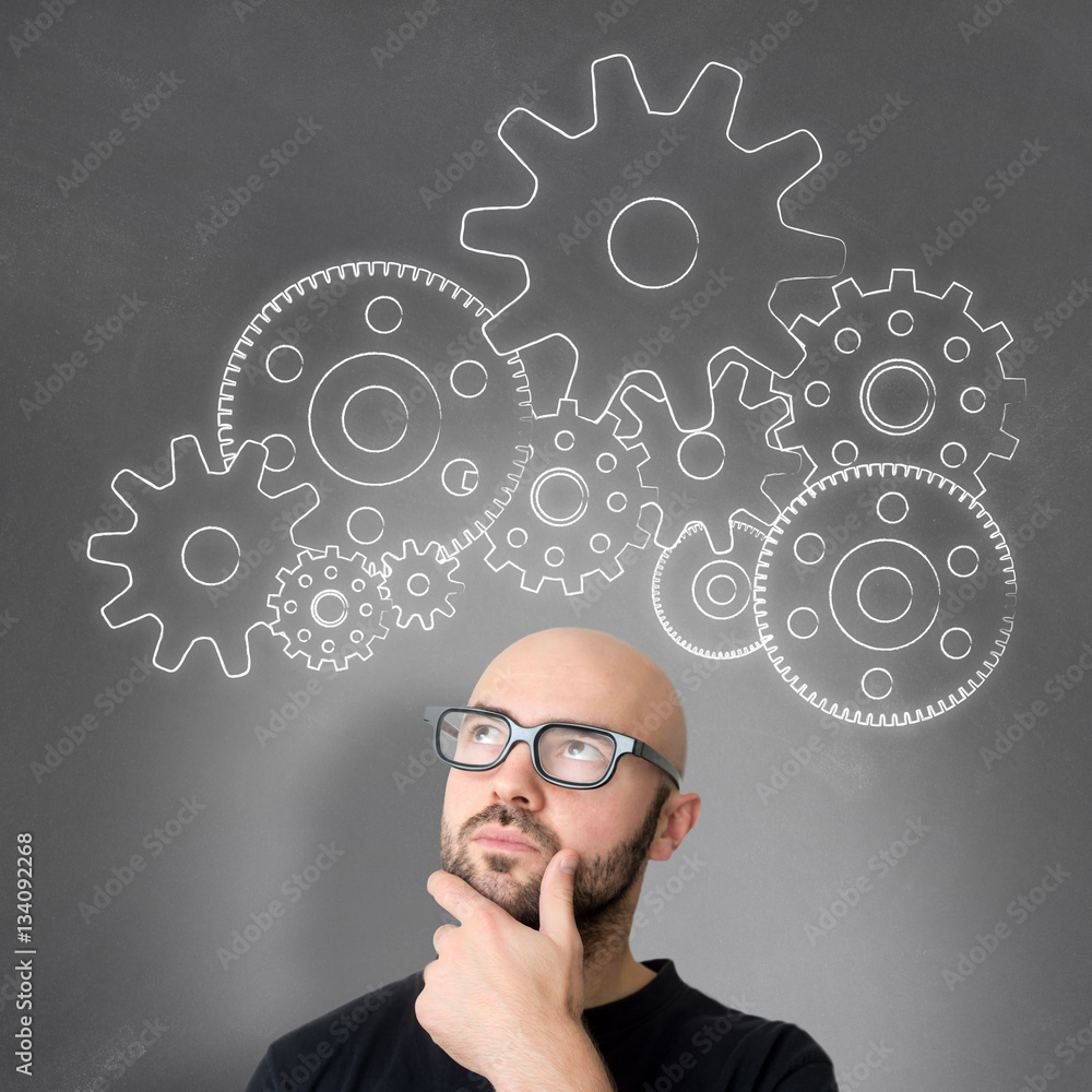 Gear wheel going out of the head of a young attractive smiling m Gear wheel going out of the head of a young attractive smiling m
