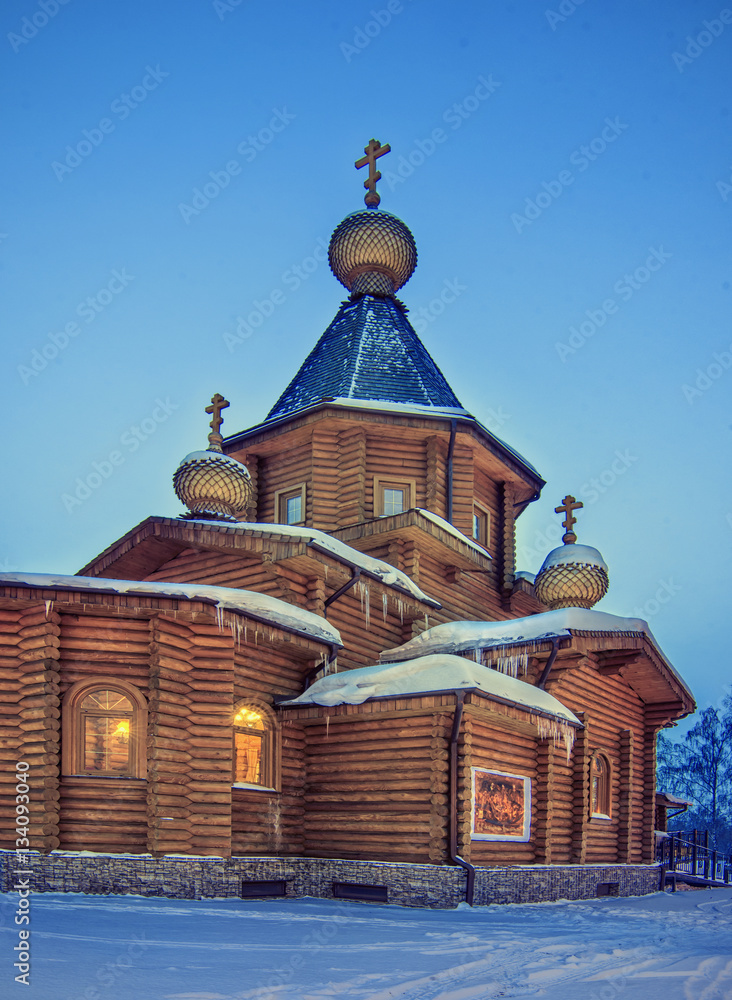 winter night landscape with old rural wooden Church with lightni