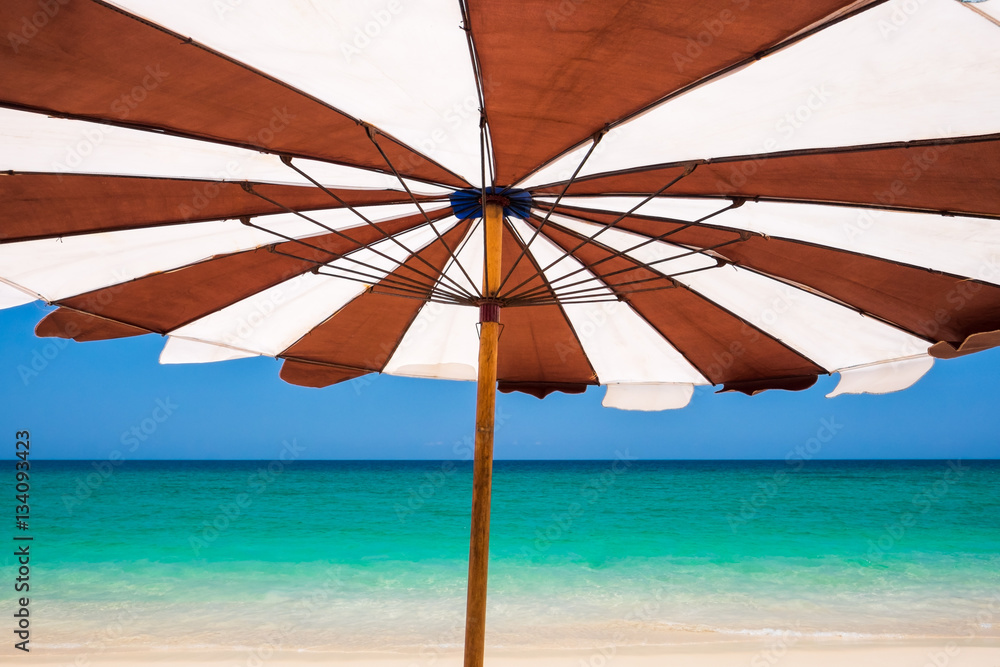 Umbrella on a tropical beach vacation. Phuket island, Thailand.