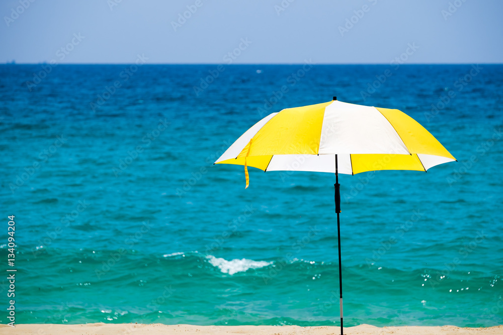Beach umbrella on a sunny day against sea background.