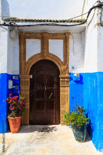 Entrance of  a house in the small streets in blue and white in t © pwollinga