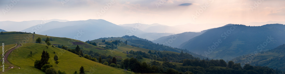 Wide sunset panorama of the Carpathian mountains. Ukraine.