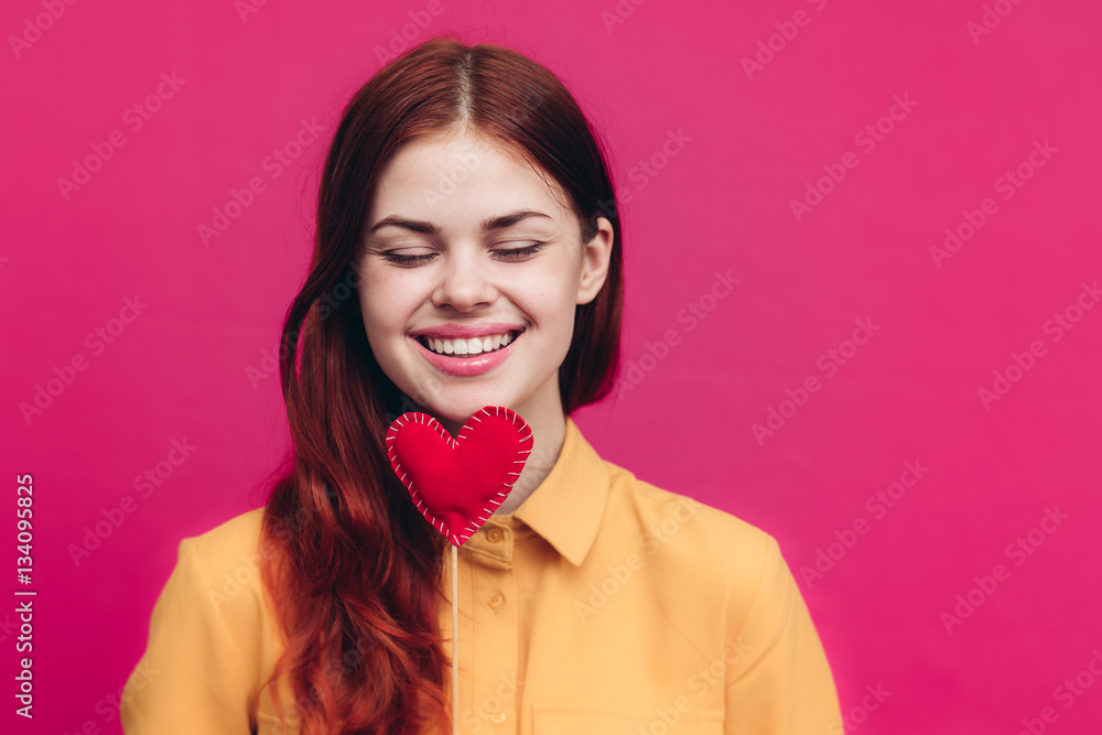 beautiful woman with red hearts on a stick, pink background beautiful woman with red hearts on a stick, pink background