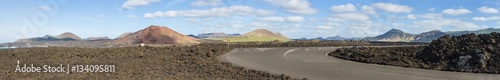 panoramic view of extinct volcanoes and a road through lava fields