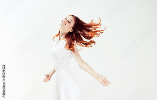 red-haired woman in a light dress  lightness
