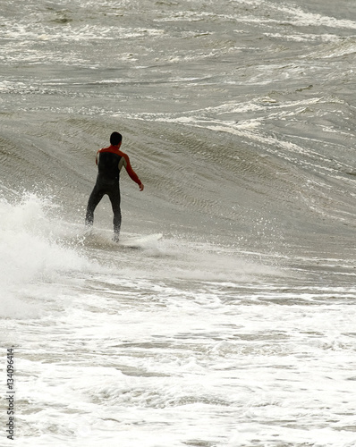 a surfer surf a wave in italy
