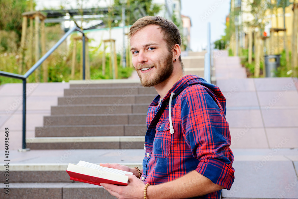 Obraz premium young man is reading a book