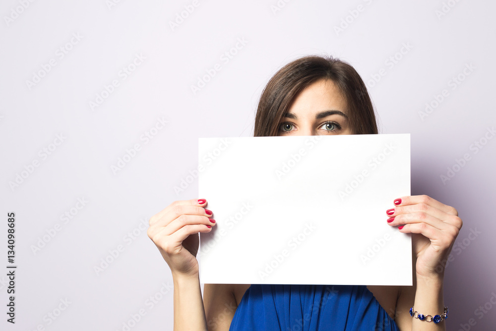 Portrait of a beautiful girl with a sheet of paper in his hands Portrait of a beautiful girl with a sheet of paper in his hands