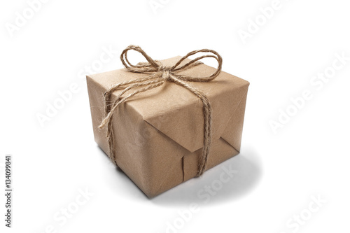 Box with a gift wrapped in Kraft paper on isolated white backgro