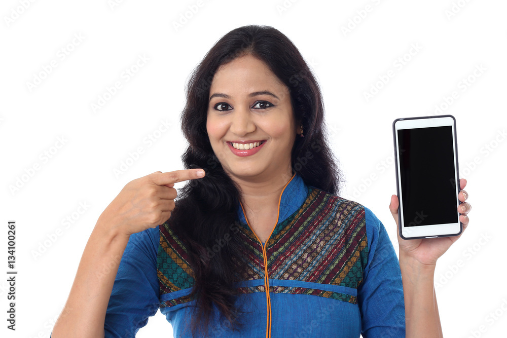 Young woman holding mobile phone against white background Young woman holding mobile phone against white background