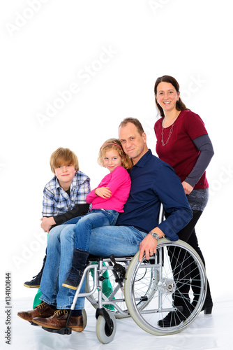 disabled man in wheelchair with his family