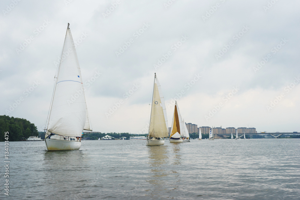 Walk on a sailing yacht on the pond, the lake, on a cloudy summer day. Walk on a sailing yacht on the pond, the lake, on a cloudy summer day.