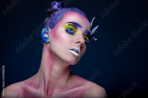 Creative portrait of woman with art make-up.