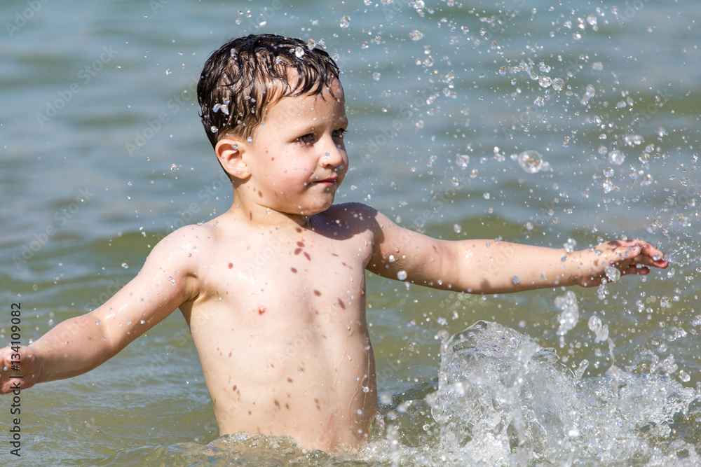 boy is bathed in the lake to the beach boy is bathed in the lake to the beach