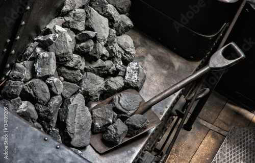 Shovel and coal in historic steam locomotive photo