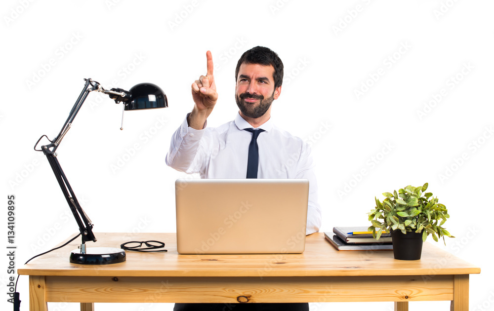 Businessman in his office touching on transparent screen Businessman in his office touching on transparent screen