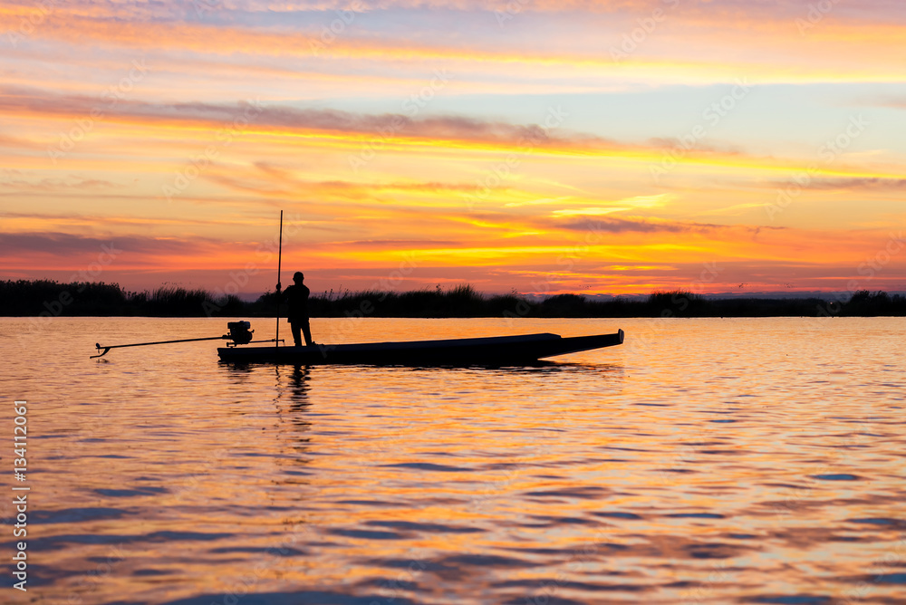 fishermen in boat on morning sunrise