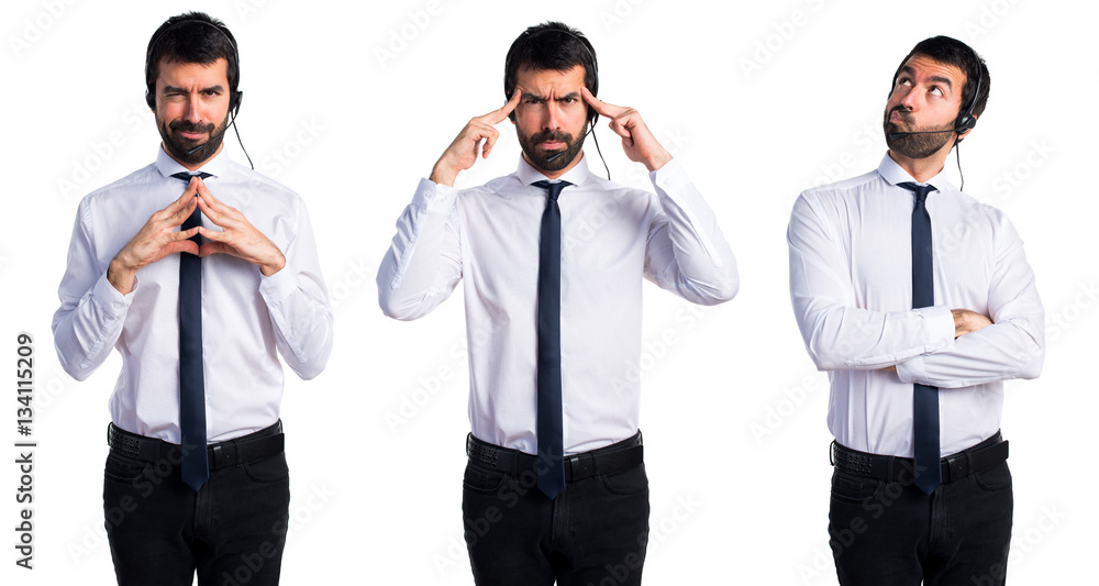 Young man with a headset thinking Young man with a headset thinking