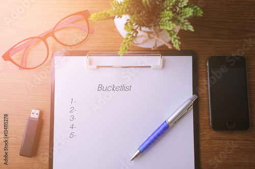 Business concept - Top view notebook writing Bucket List. photo