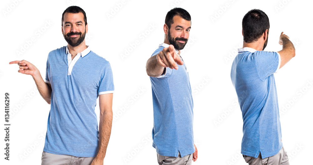 Man with blue shirt pointing to the front Man with blue shirt pointing to the front