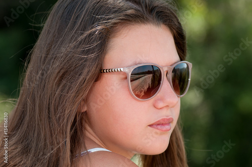 Young, teenage girl in sunglasses
