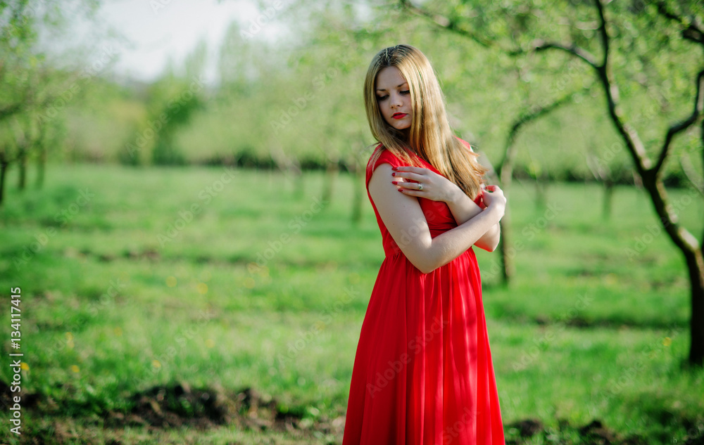 Portrait of light hair girl on red dress background spring garde Portrait of light hair girl on red dress background spring garde