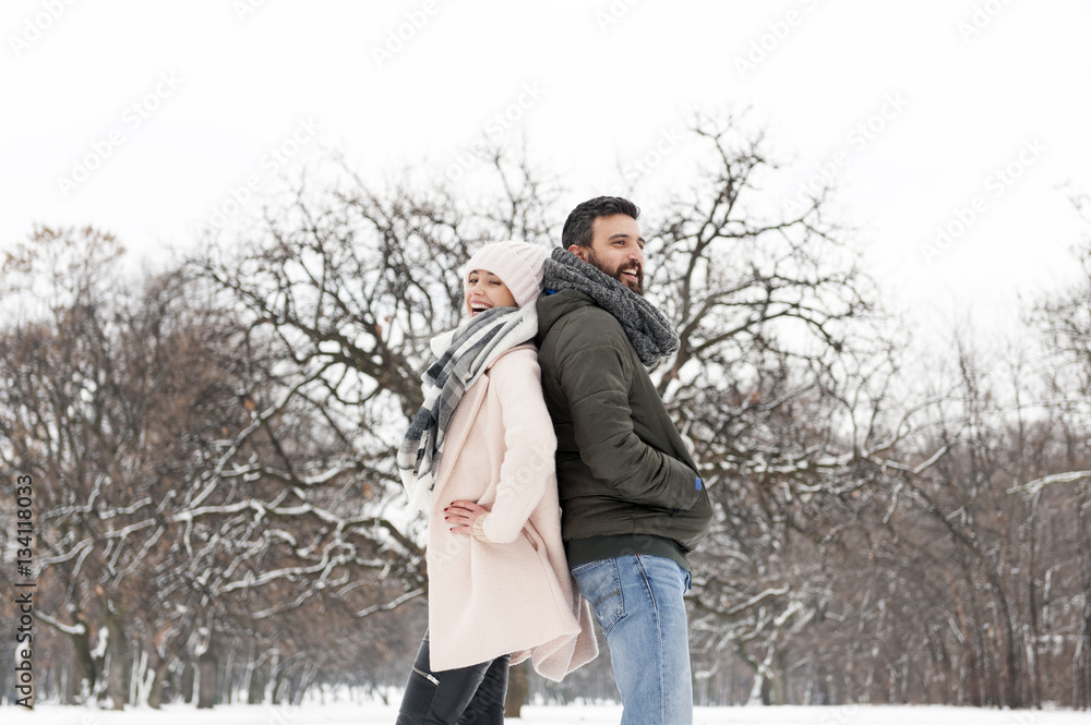 Loving couple enjoying the snow in the park Loving couple enjoying the snow in the park