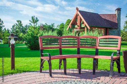 Chairs and glass table on brick terrace at countryside 