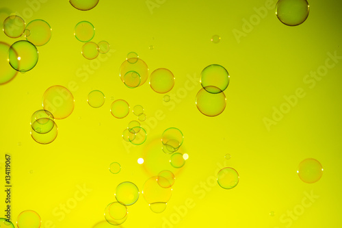 Soap bubbles yellow abstract background