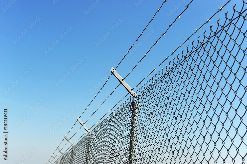 iron chain link fence and blue sky iron chain link fence and blue sky