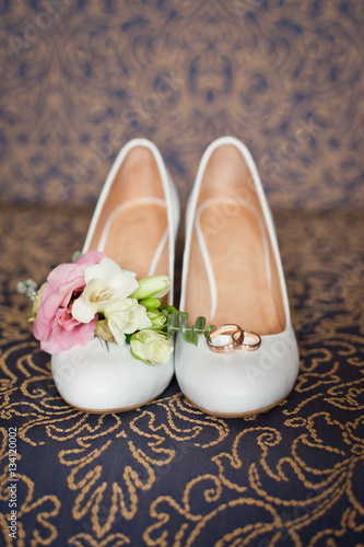 Bridal accessories: shoes and wedding bouquet or buttonhole. Wedding accessories: Bride's shoes and boutonniere