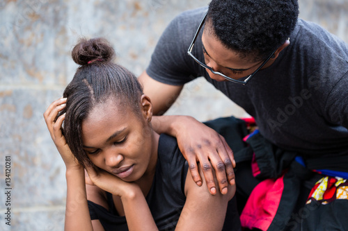 Young man trying to make up with his girlfriend upset after a fi