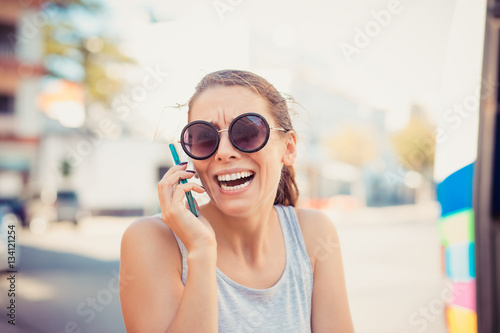 Portrait surprised laughing smiling screaming woman looking at phone