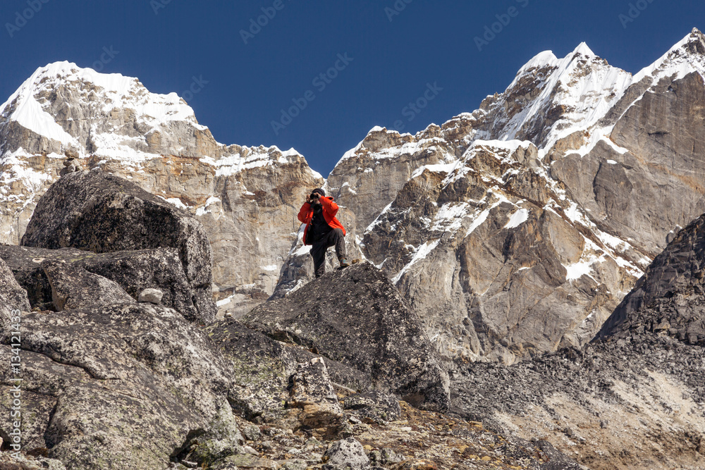 Mountain Climber in warm Jacket taking Picture