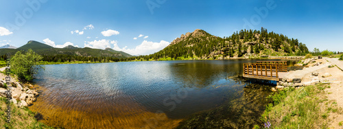 Wooden pier on lake against mountain panorama